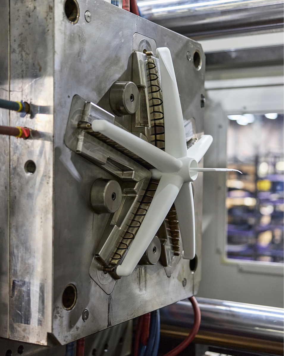 Close-up of a mechanical component with gears and metal parts in an industrial setting.